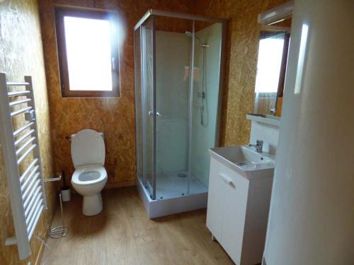 a bathroom with a shower and a toilet and a sink at Le Carbet Vendéen in Bouillé-Courdault