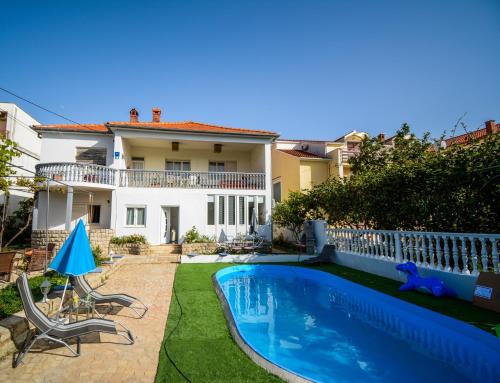 a villa with a swimming pool and a house at Studio Zadar 17553a in Zadar