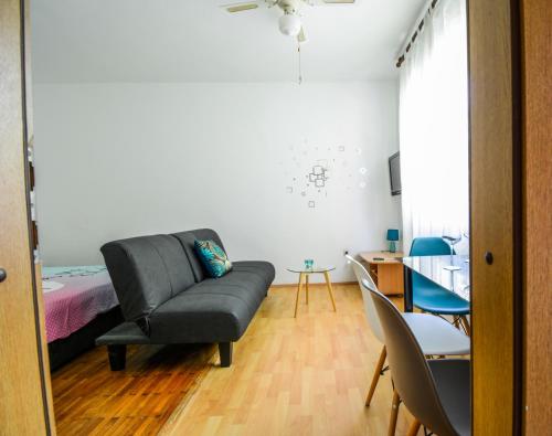 a living room with a couch and a bed at Studio Zadar 17553a in Zadar