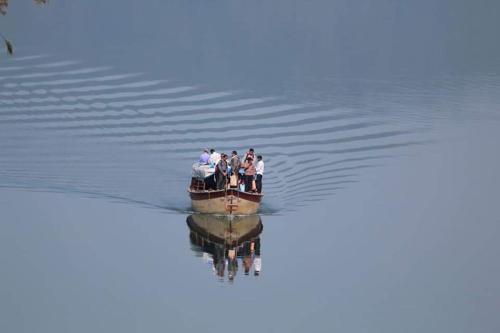 a group of people in a boat on the water at Omkar Agro Tourism & Resort in Mahabaleshwar