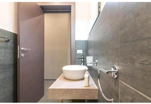 een badkamer met een witte wastafel en een douche bij La casa di Alessandro in Noto