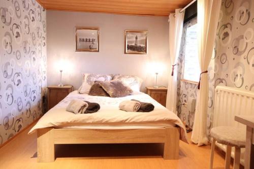 a bedroom with a bed with two pillows on it at My little corner in Burg-Reuland