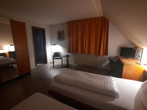 a hotel room with a bed and a window at Hotel Lamm in Nufringen