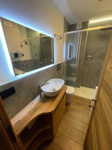a bathroom with a sink and a toilet and a shower at Baita del Cervino CIR n 0016 in Breuil-Cervinia