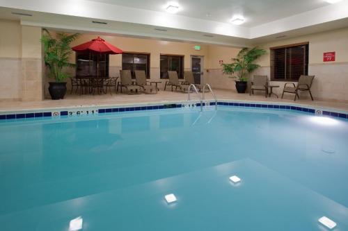 a pool at a hotel with chairs and tables at Holiday Inn Express Hotel Vernal by IHG in Vernal