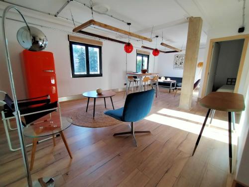 a living room with a blue chair and a table at Lotila Flats Mieres in Mieres