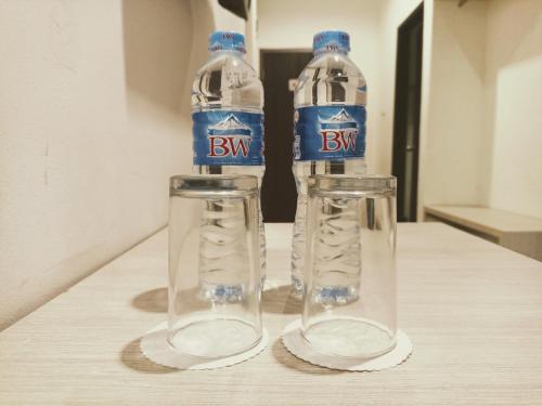 two bottles of water sitting on top of a table at Yunna Express in Geruntang