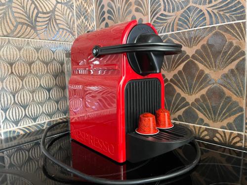 a red toaster sitting on top of a table at Lenio’s in Karistos