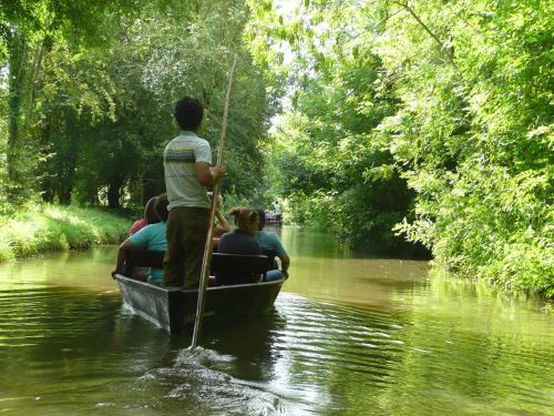 a group of people in a boat on a river at Le Carbet Vendéen in Bouillé-Courdault