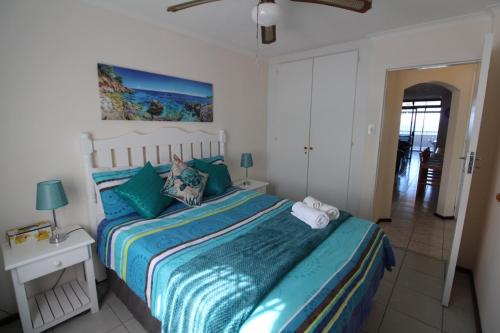 a bedroom with a bed with a colorful bedspread at Mont Blanc 17 in Margate