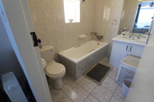 a bathroom with a tub and a toilet and a sink at Mont Blanc 17 in Margate