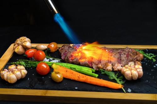a piece of meat with vegetables on a tray at OCEAN HOTEL in Phnom Penh