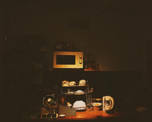 a microwave sitting on top of a shelf at Nấp Đà Lạt in Da Lat
