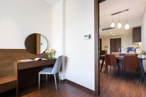 a kitchen and dining room with a table and chairs at DHTS Business Hotel & Apartment in Ho Chi Minh City