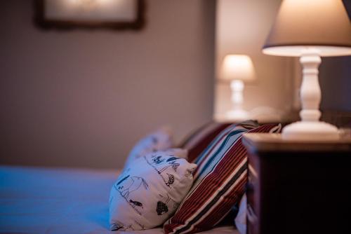 a child laying on a couch next to a lamp at Hotel Mas de Xaxas in Camprodon