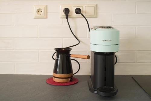 a coffee maker and a coffee pot on a counter at Spectacular apartment near Dance Hall/Center in Kalamata