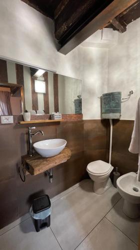 a bathroom with a sink and a toilet at Toscana Made in Love in Massa