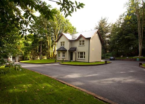 a white house on a street with a driveway at Ballyseede Castle in Tralee
