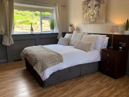 a bedroom with a large bed and a window at Mountain House Omeath near Carlingford in Ó Méith