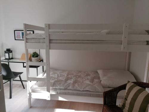 a bedroom with two bunk beds and a desk at Townhouse Altstadt Wismar, Lower Apartment in Wismar