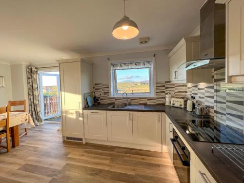 a kitchen with a sink and a counter top at Lingeigh in Pollachar
