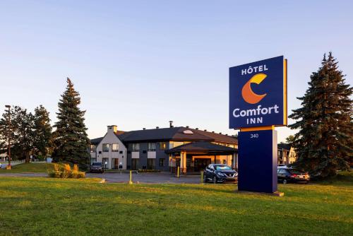 a hotel sign in front of a carport inn at Comfort Inn Aeroport in Dorval