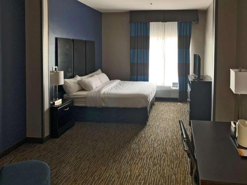 a hotel room with a bed and a window at Comfort Inn & Suites Columbus North in Columbus