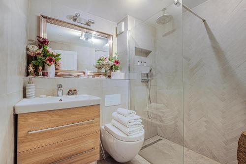 a bathroom with a shower and a toilet and a sink at Charming one bedroom flat near Maida Vale by UnderTheDoormat in London