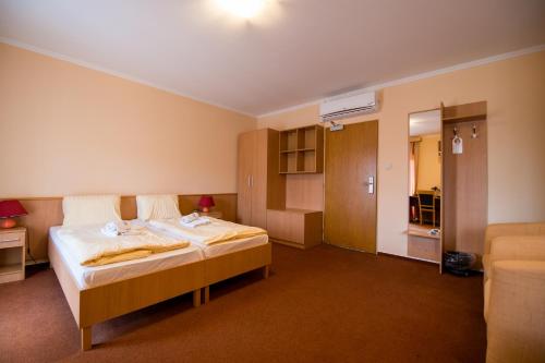 a hotel room with a bed in a room at Hotel Clavis in Lučenec