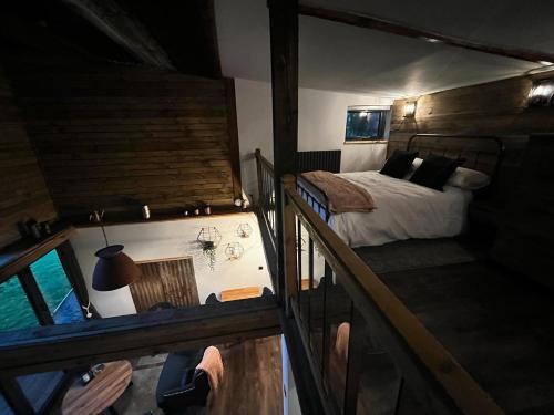 a bedroom with a bed on a boat at Lynbrook Haybarn, Hot tub and outdoor kitchen, New Forest in Ringwood