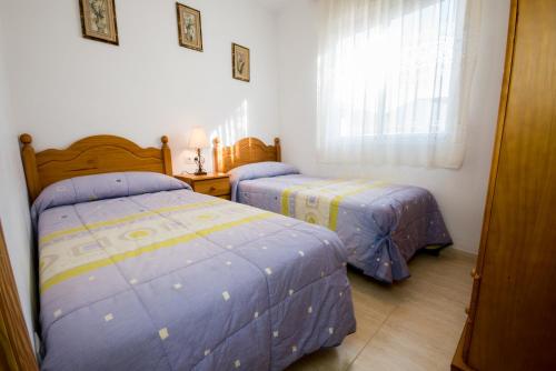 Posteľ alebo postele v izbe v ubytovaní Apartamentos rurales Benafer