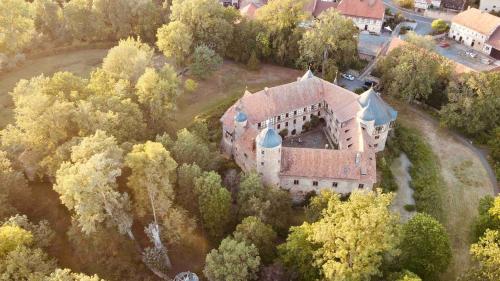 an aerial view of a castle in the trees at Urlaub im Wasserschloss Irmelshausen in Höchheim