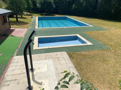 a swimming pool in the middle of a yard at ACOGEDOR PISO EN SORT CON PISCINA in Sort