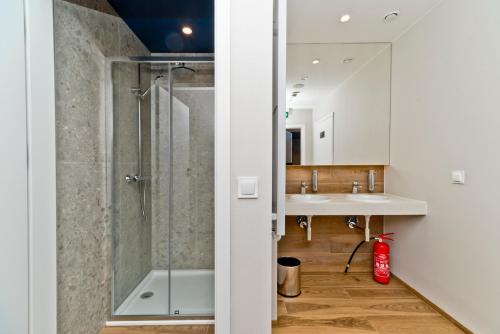 a bathroom with a shower and a sink at BlueApart Apartamenty Hotelowe Nexo in Puck