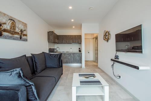 a living room with a couch and a table at Cozy Penthousestudio Cityview W12 in Bucharest