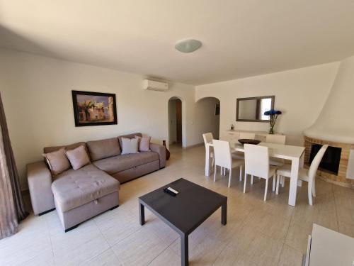 a living room with a couch and a table at Apartamentos Mar-Sol Villas in Vilamoura