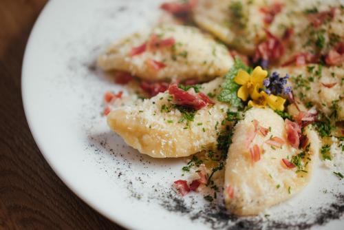 a white plate with food on a table at Plattnerhof Viums in Natz-Schabs