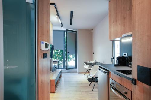 a kitchen with wooden cabinets and a counter top at Souda Plaza Collection in Souda