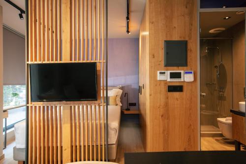 a hotel room with a television and a bathroom at Souda Plaza Collection in Souda