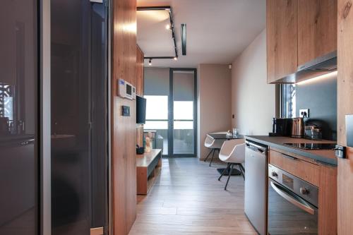 a kitchen with wooden cabinets and a counter top at Souda Plaza Collection in Souda