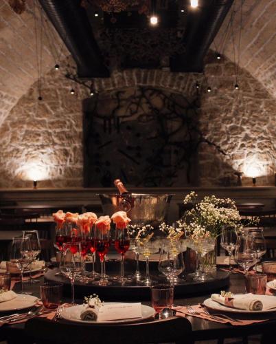 a table with wine glasses on it in a restaurant at Hotel Buna Mostar in Buna