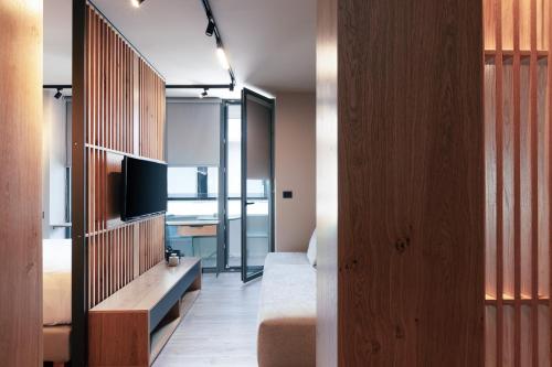 a living room with a couch and a television in a room at Souda Plaza Collection in Souda