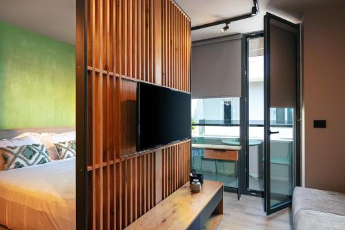 a bedroom with a bed and a tv in a room at Souda Plaza Collection in Souda