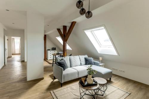 a living room with a couch and a skylight at Sweet Hotel Da Giovanni in Gladenbach