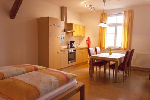 a kitchen with a table and a dining room at Unterfrickhof in Owingen