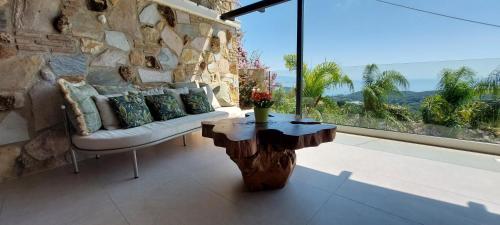 a living room with a couch and a large window at Filoxenia Sea View in Parga