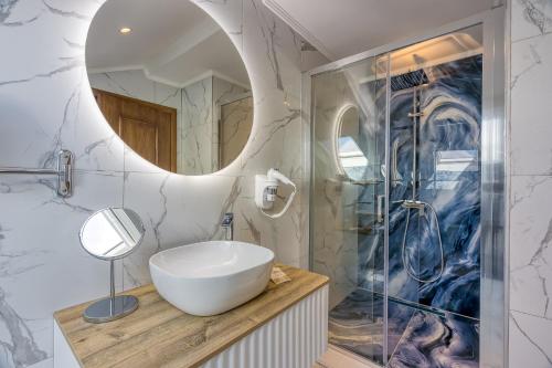 a bathroom with a sink and a mirror at San Valentino Palace in Umag