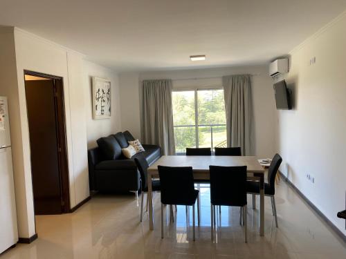 ein Wohnzimmer mit Tisch und Stühlen und einer Couch in der Unterkunft Departamento con vistas al lago en Veneto Village in Villa Parque Siquiman