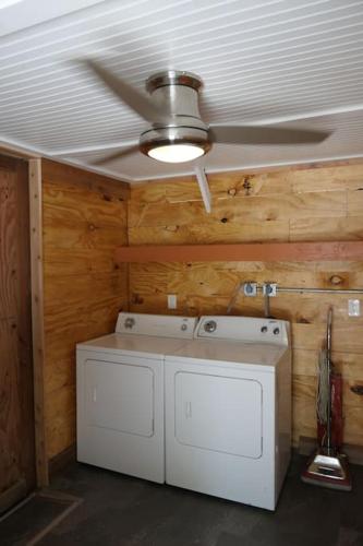 a kitchen with a ceiling fan and a washer and dryer at Barra Villa Resort House II in Fort Myers