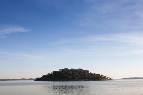 an island in the middle of a body of water at Monte Farropo in Monsaraz